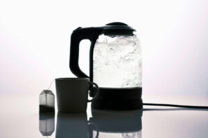 Electric kettle with water inside on the table