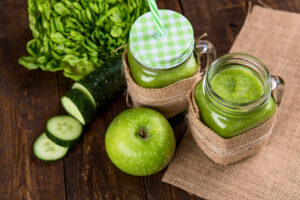 Two Clear Glass Jars of Green Juice